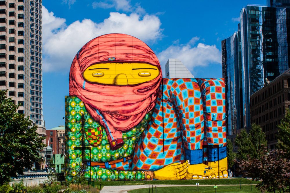 Os Gêmeos, two Brazilian twins who are famous for being at the forefront of Brazilian street art, have their first US solo show at the ICA in Boston. As part of the exhibit, they converted an air intake structure into this whimsical and colorful character on the Greenway in Boston, MA (Tim Sackton/Flickr) 