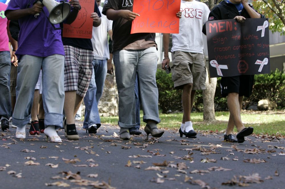 Male students at Ramapo College walk in women's shoes for a march against violence against women in 2008.  (Mike Derer/AP)