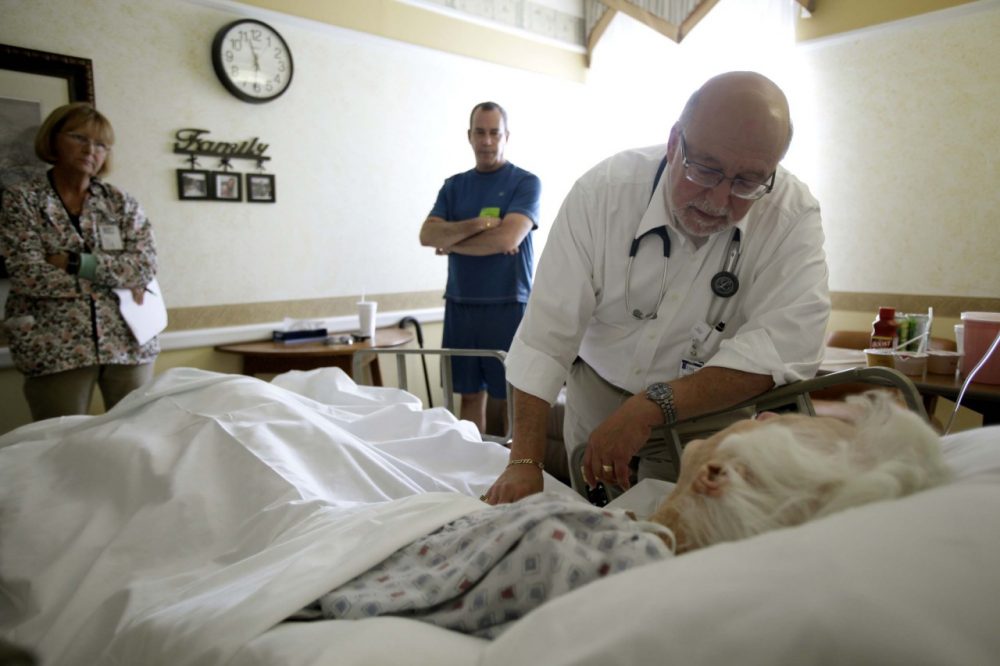 In this 2009 file photo, Dr. Joel Policzer checks on Lillian Landry in the hospice wing of an Oakland Park, Florida, hospital. Unlike most of Policzer's patients she made end-of-life decisions. (AP)