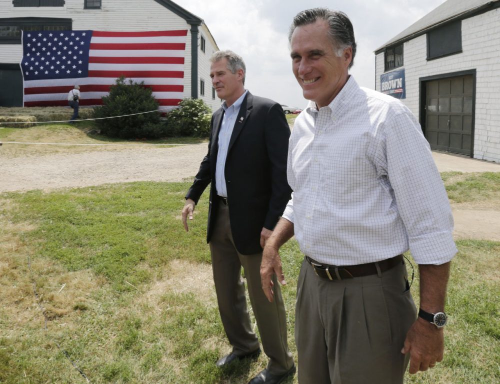 Mitt Romney, the former Republican presidential nominee, stands with New Hampshire Senate candidate Scott Brown, left, as they wait to be introduced during a campaign stop at a farm in Stratham, N.H., Wednesday, July 2, 2014.  Brown, who is facing incumbent Democrat U.S. Sen. Jeanne Shaheen, was endorsed by Romney at the event.  (Charles Krupa/AP)