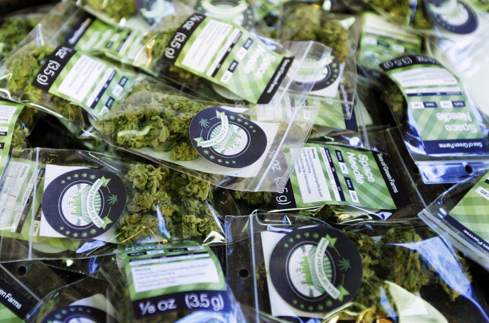 In this photo taken Tuesday, July 1, 2014, packets of a variety of recreational marijuana named &quot;Space Needle&quot; are shown during packaging operations at Sea of Green Farms in Seattle. The grower, the first business licensed to grow recreational marijuana in Washington state, worked all weekend to have supplies ready for stores that were expected to be granted sale licenses on Monday, July 7, the day before legal recreational pot sales begin on July 8. (Ted S. Warren/Associated Press)