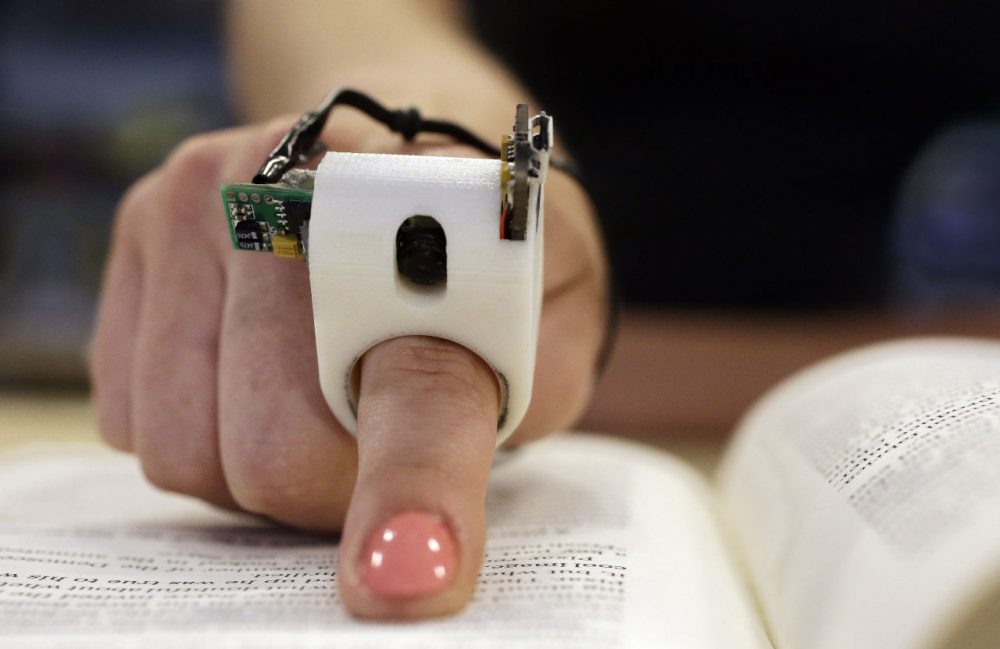 A model wears a FingerReader ring at MIT's Media Lab in Cambridge. (Stephan Savoia/AP)