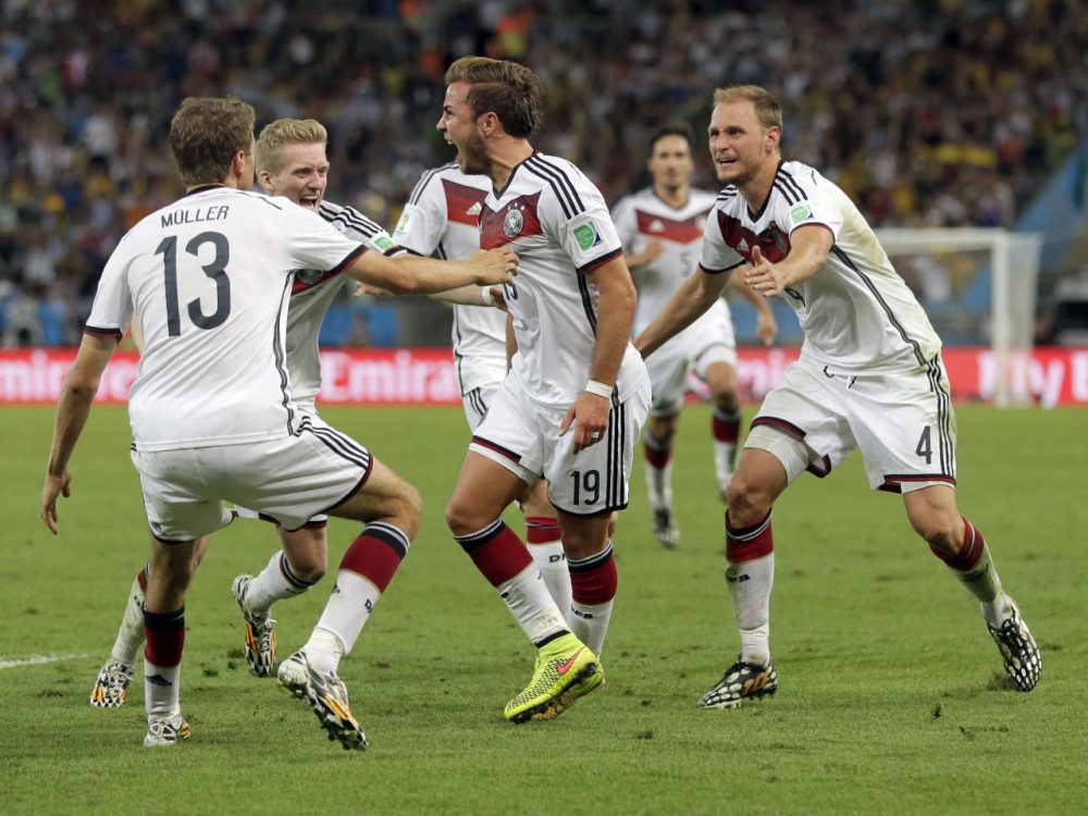 Germany's Mario Goetze (19) celebrates with teammates after scoring his side's first goal in extra time against Argentina's goalkeeper Sergio Romero during the World Cup final soccer match between Germany and Argentina at the Maracana Stadium in Rio de Janeiro, Brazil, Sunday, July 13, 2014. (Felipe Dana/AP)