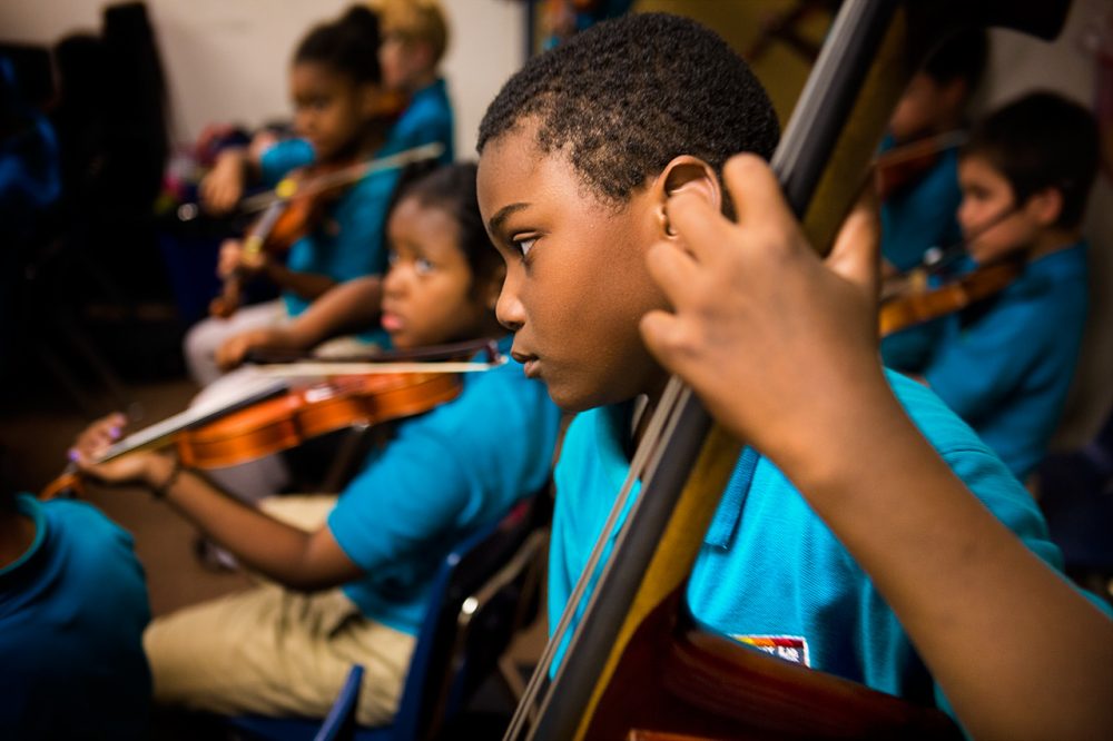 A bassist at the Conservatory Lab Charter School in Boston plays during a recital rehearsal. Research has found music instruction has beneficial effects on young brains. (Jesse Costa/WBUR)