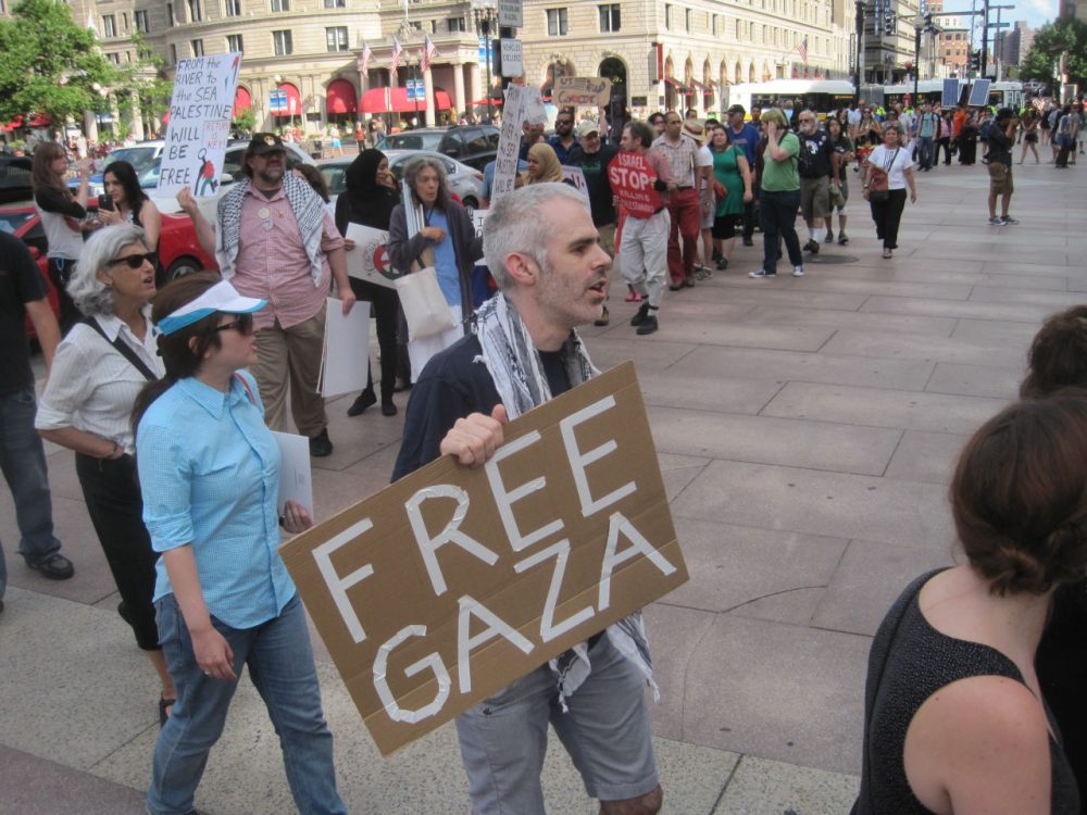 Pro-Palestinian demonstrators march in front of Boston Public Library on Thursday.