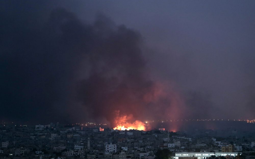 Smoke rises in the air as flame spread across buildings after Israeli strikes in Shijaiyah neighborhood in Gaza City, July 20, 2014. Escalating their ground offensive, Israeli troops backed by tanks and warplanes battled Hamas militants in the crowded neighborhood early Sunday. The fighting, including heavy Israeli tank fire, killed scores of Palestinians, forced thousands to flee and damaged or destroyed dozens of homes. (Khalil Hamra/AP)