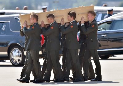 Dutch military men carry coffins containing the remains of victims of downed Malaysia Airlines flight MH17, during a ceremony at Eindhoven Airbase on July 23, 2014, after a Hercules transport plane carrying the coffins landed from Ukraine. (John Thys/AFP/Getty Images)