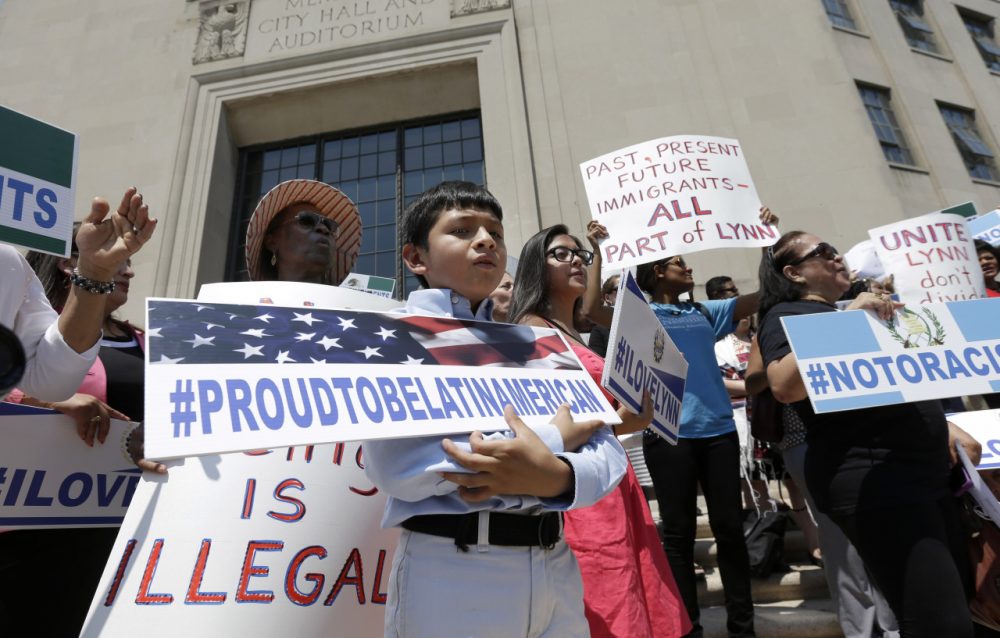 Christian Gonzalez, 9, of Lynn, Mass., displays a placard during a rally, Tuesday, July 22, 2014, on the steps of City Hall, in Lynn, held to protest what organizers describe as the scapegoating of immigrants for problems in the city. The mayor of Lynn and education officials complain their schools are being overwhelmed by young Guatemalans who speak neither English or Spanish as their first language. Gonzalez, a U.S. citizen, was born in Boston. (AP)