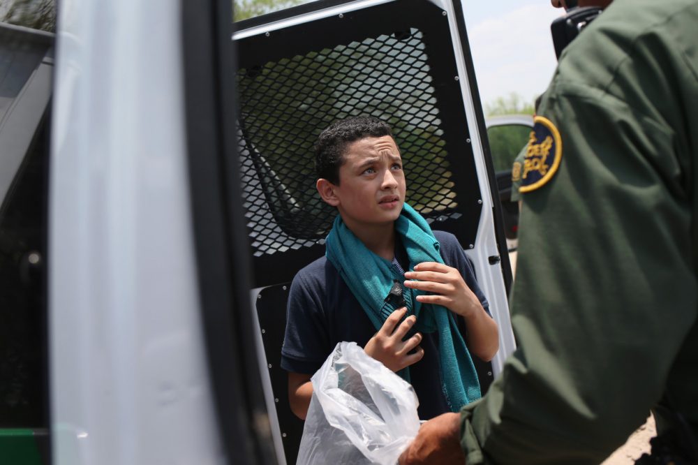 A U.S. Border Patrol agent prepares to take an unaccompanied Salvadorian minor, 13, to a processing center after he crossed the Rio Grande from Mexico into the United States on July 24, 2014 in Mission, Texas. Tens of thousands of unaccompanied minors and immigrant families have crossed illegally into the United States this year and presented themselves to federal agents, causing a humanitarian crisis on the U.S.-Mexico border. (John Moore/Getty Images)