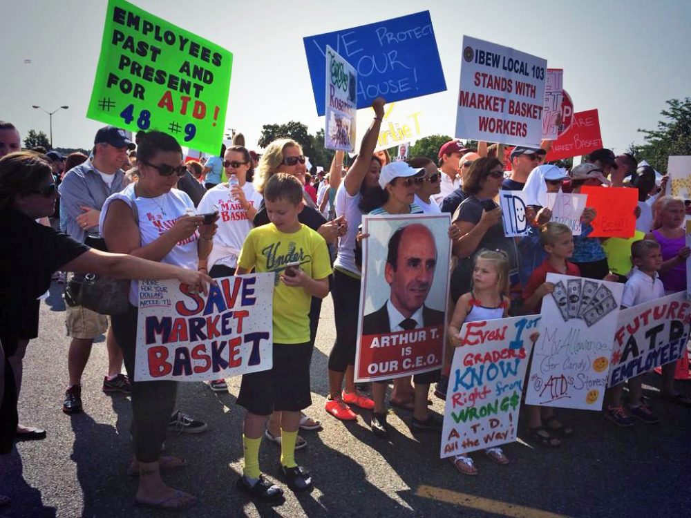 Hundreds of supporters of ousted Market Basket CEO Arthur T. Demoulas gathered in Tewksbury Friday morning. Many protesters carried signs calling for the reinstatement of the ex-CEO, who released a statement earlier this week saying he had offered to buy the supermarket chain. 