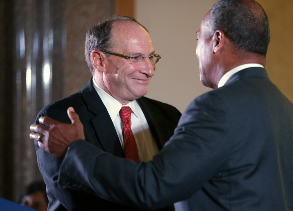 Chief Justice of the Supreme Judicial Court Ralph Gants, left, embraces Mass. Gov. Deval Patrick, right, seconds after being sworn in by Patrick as chief justice during ceremonies at the John Adams Courthouse on Monday. (Steven Senne/AP)