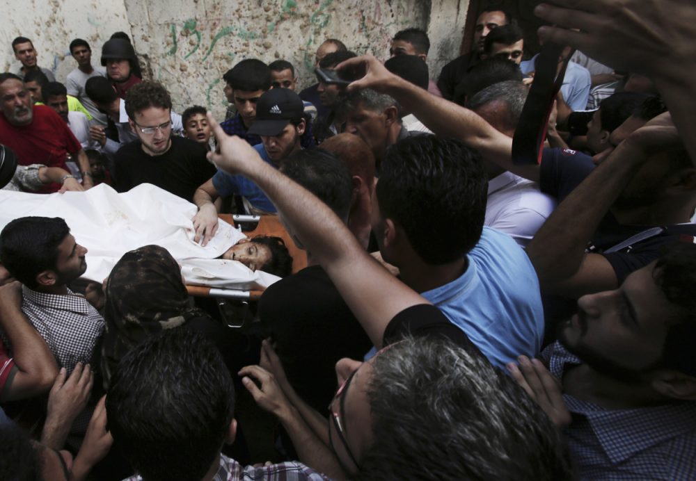 Palestinians carry the body of Gamal Ielian, 10, who was killed along with 9 other people, all but one of them children, in an explosion at a park at the Shati refugee camp in the northern Gaza Strip Monday. (Adel Hana/AP)