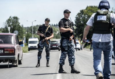 Pro-Russian militants block the road behind Dutch and Australian forensic teams on their way to the crash site of the Malaysia Airlines flight MH17 on July 28, 2014 in Donetsk. Dutch and Australian forensic investigators turned back on their way to the MH17 crash site on July 28, after 'explosions' in the area, a government spokeswoman in The Hague said. (Bulent Kilic/AFP/Getty Images)