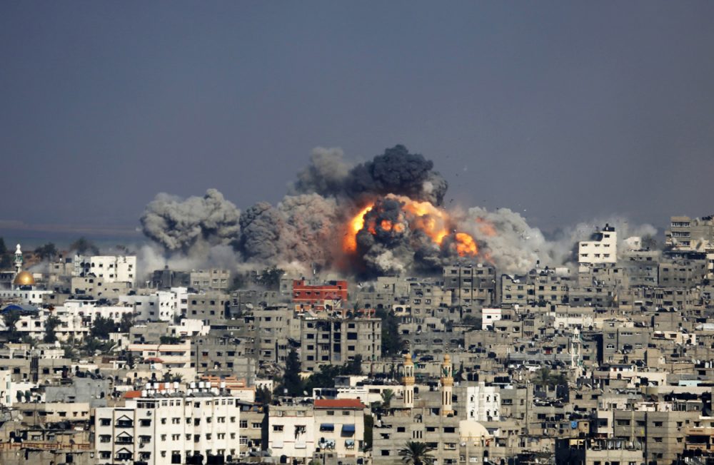 Smoke and fire from the explosion of an Israeli strike rise over Gaza City Tuesday. (Hatem Moussa/AP)