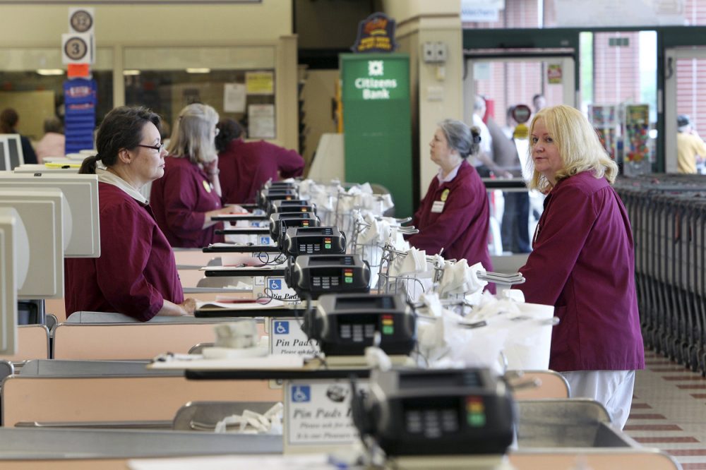 Cashiers and baggers stand idle at a Market Basket in Concord New Hampshire last week. A decades-long family feud, which brought about the ouster of Arthur T. Demoulas as CEO of the privately held company, led to a worker revolt, customer boycotts and empty shelves in the grocery chain's stores in Maine, Massachusetts and New Hampshire. (AP)