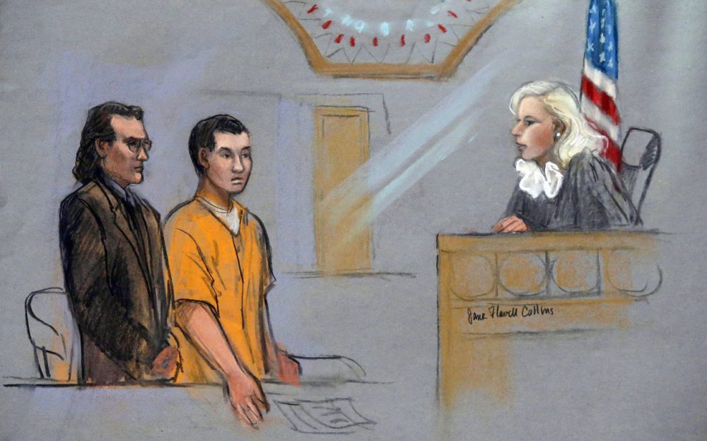 In this courtroom sketch, defendant Azamat Tazhayakov, center, a college friend of Boston Marathon bombing suspect Dzhokhar Tsarnaev, stands for arraignment with his attorney, Nicholas Wooldridge, left, before Federal Magistrate Marianne Bowler, Friday, Sept. 13, 2013 at the Moakley Federal Courthouse in Boston. Tazhayakov pleaded not guilty to hindering the investigation into the attack. (AP)
