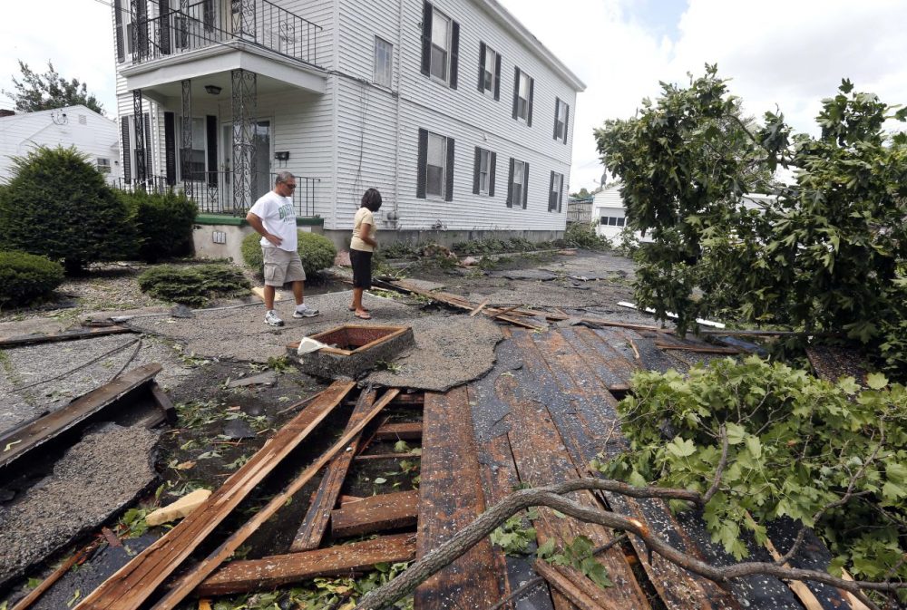 Christine Molle and her husband, Wayne, survey the damage to her mother's house. (Elise Amendola/AP)