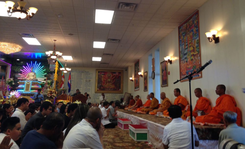 Monks lead gatherers in prayer at the Glory Buddhist Temple in Lowell. (Kassandra Sundt/WBUR)