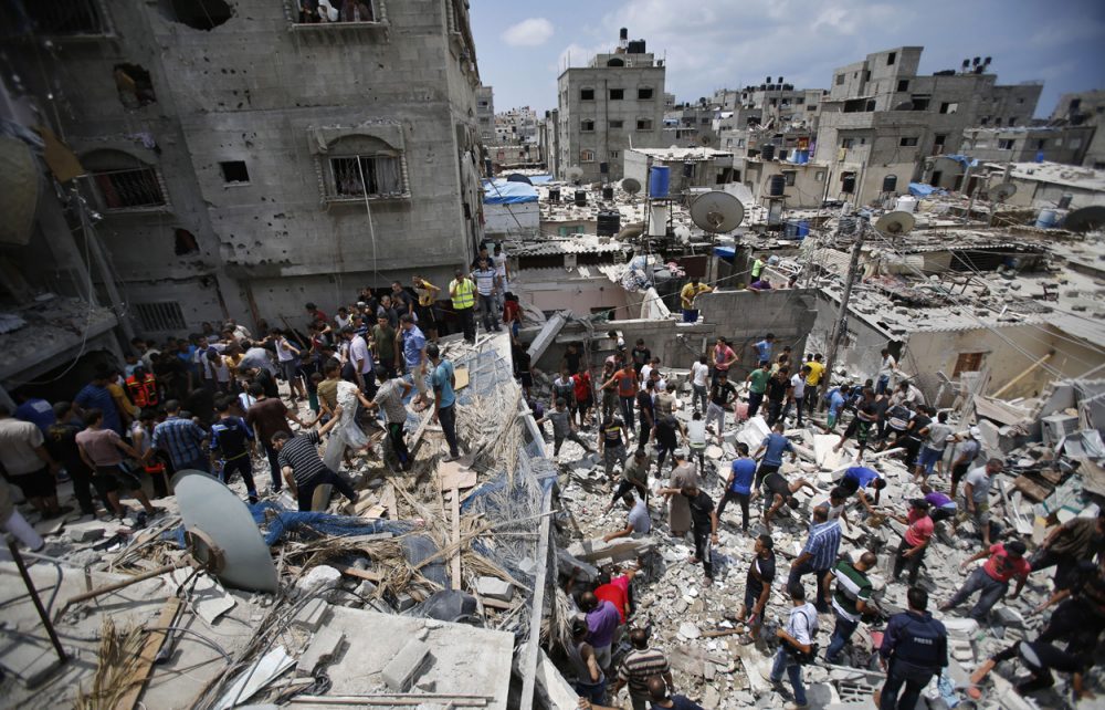 Palestinians look for survivors under the rubble of the al-Bakri family home destroyed by an Israeli strike in Gaza City Monday. (Hatem Moussa/AP)