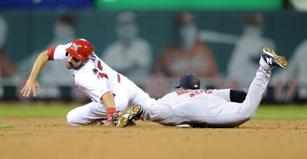 St. Louis Cardinals' Matt Carpenter, left, is tagged out stealing by Boston Red Sox's Xander Bogaerts. (AP/Bill Boyce)
