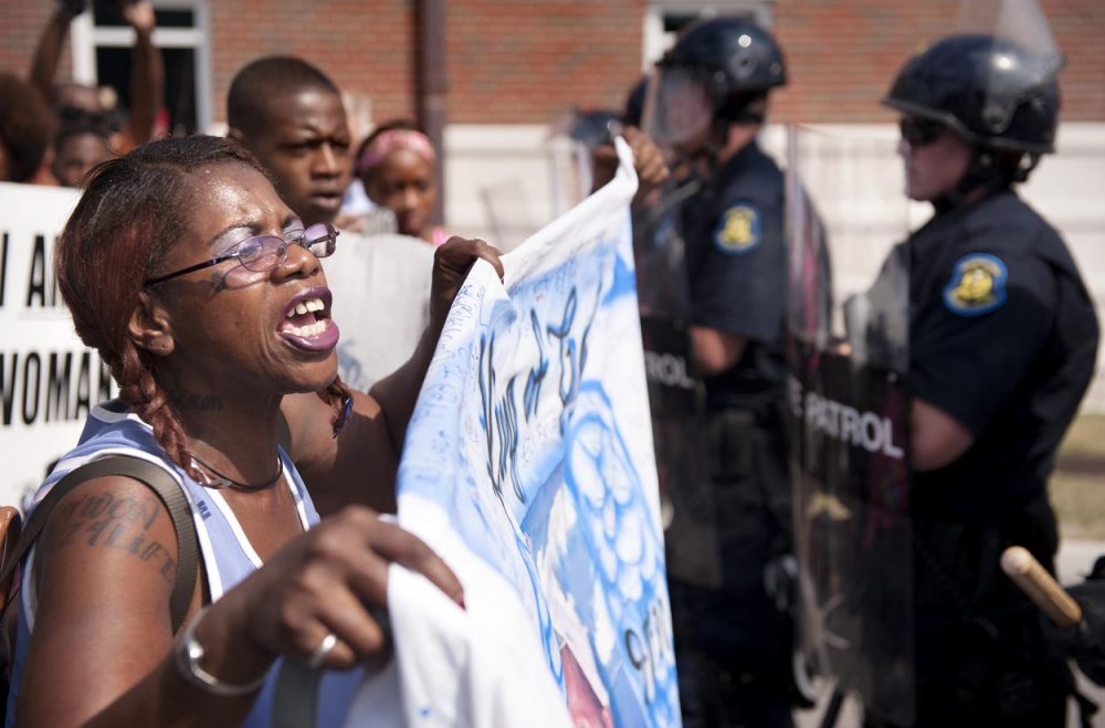Marcelle Stewart, left, confronts police officers during a march and rally in downtown Ferguson, Mo., on Monday (Sid Hastings/AP)
