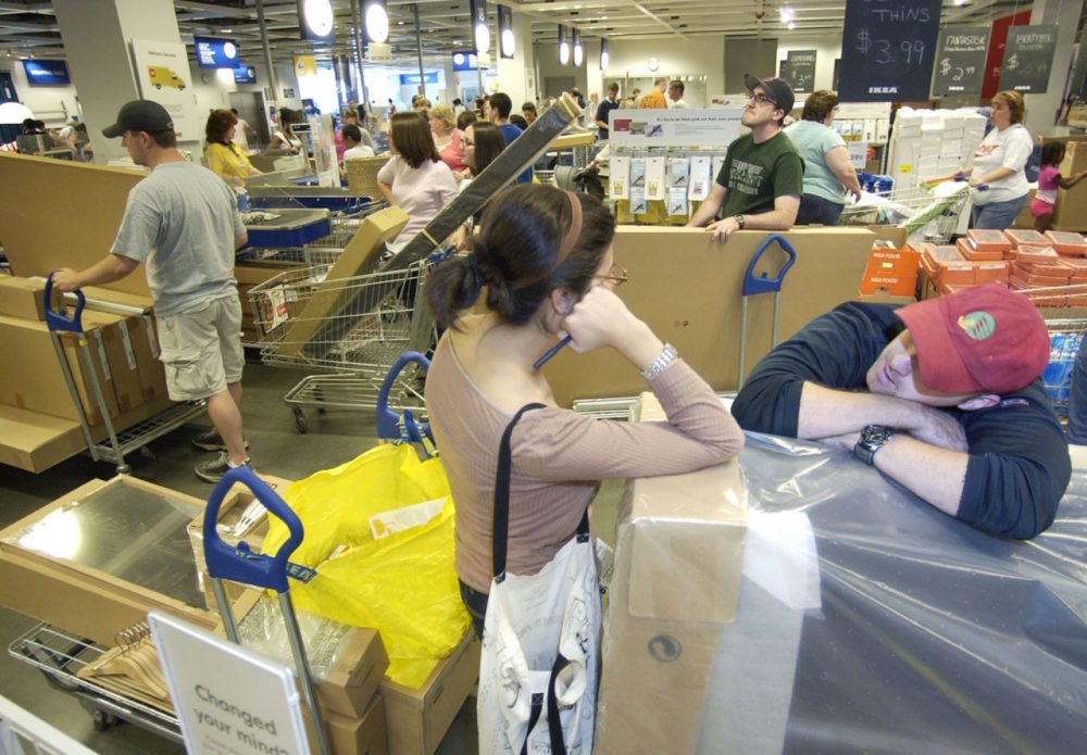 Sharon Squillace, center, and Glen Daly, right, both from Boston, wait in line after shopping tax free at IKEA in Stoughton, Mass. in 2007. (Lisa Poole/AP)