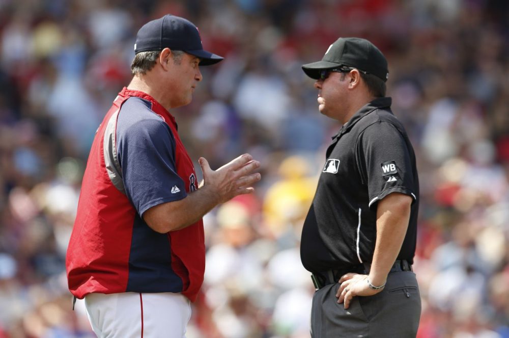 Boston Red Sox manager John Farrell, left, talks with first base umpire Doug Eddings as a play at second base is reviewed during the second inning.  (Michael Dwyer/AP)
