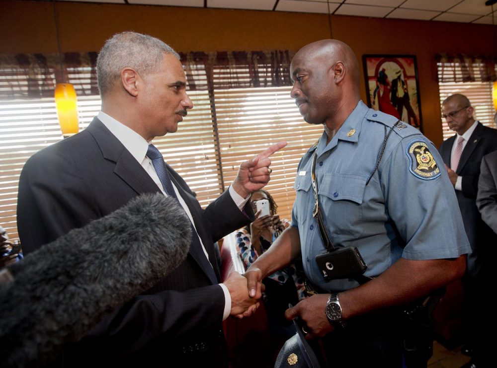 Attorney General Eric Holder talks with Capt. Ron Johnson of the Missouri State Highway Patrol at Drake's Place Restaurant Wednesday in Missouri. (Pablo Martinez Monsivais/AP/Pool)