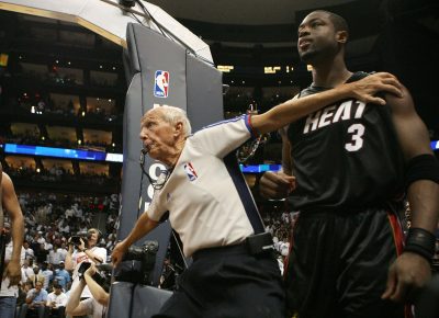 Dick Bavetta restrains Miami's Dwyane Wade during a playoff game against Atlanta in 2009. Bavetta retired this week after 39 years of calling NBA games. (Doug Benc/Getty Images)