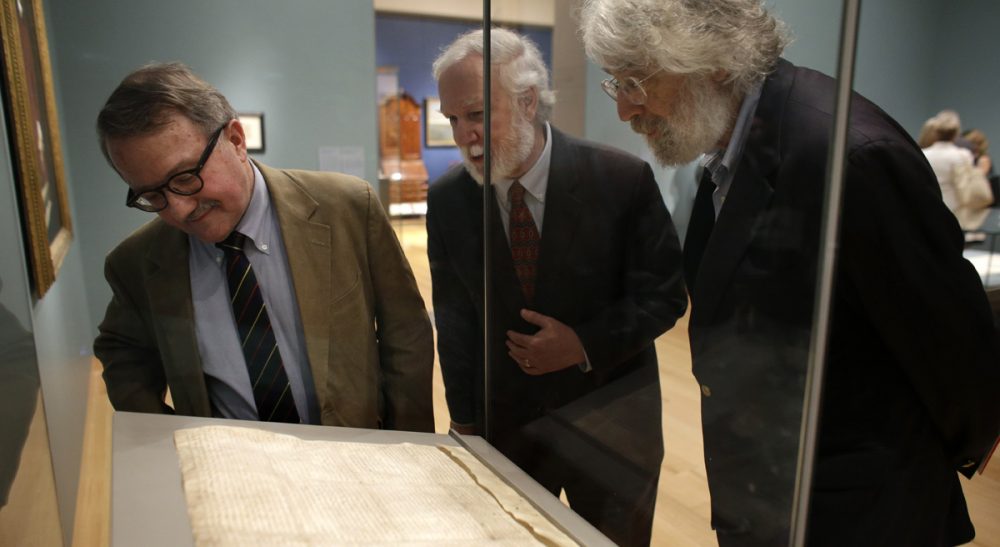 The Magna Carta is a foundational document of democracy. But it's also a reminder that power and wealth go hand in hand.  Pictured: Peter Drummey, of the Massachusetts Historical Society, left, Exhibition Curator and New Hampshire State Rep. Gerald Ward, D-Portsmouth, center, and Lloyd Schwartz, of Somerville, Mass., right, look at a copy of the Magna Carta in a display case at Boston's Museum of Fine Arts, Monday, June 30, 2014. (Steven Senne/AP)