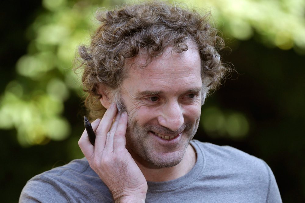 Peter Theo Curtis smiles as he talks with reporters outside his mother's home in Cambridge Wednesday. Curtis, a freelance reporter who wrote under the byline Theo Padno and who had been held hostage for about two years in Syria, returned to the U.S. Tuesday. (Charles Krupa/AP)