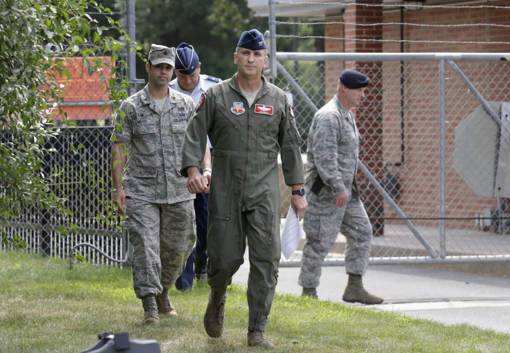 U.S. Air National Guard Col. James Keefe, commander of the 104th Fighter Wing, center, approaches members of the media outside the main gate of Barnes Air National Guard Base, in Westfield, Mass. to discuss the jet crash. (Steven Senne/AP)
