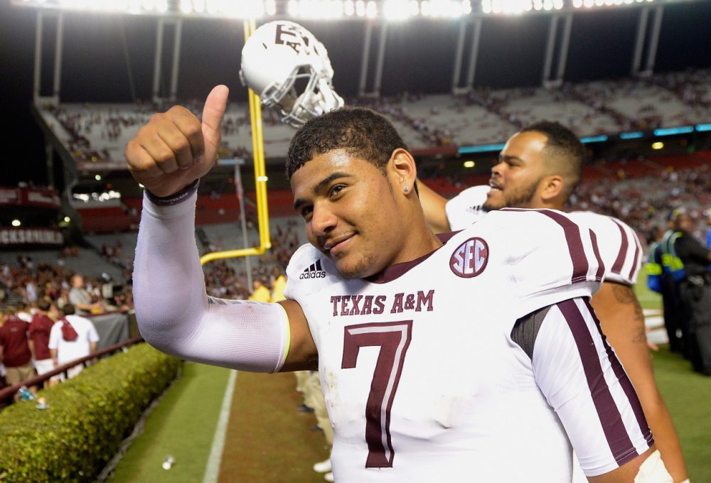 Texas A&amp;M quarterback Kenny Hill flashes a thumbs up after breaking Johnny Manziel's single-game passing record. (Grant Halverson/Getty Images)