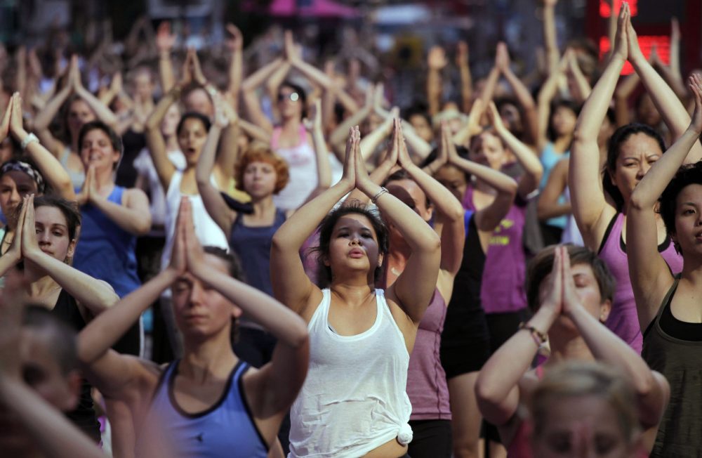 Anita Diamant: &quot;His approach -- making yoga accessible to everybody -- is not sweaty or sexy. Which isn’t to say that it’s easy.&quot; Pictured: Thousands of yoga enthusiasts convene in New York's Times Square to mark the summer solstice, Wednesday, June 20, 2012. (Mark Lennihan/AP)