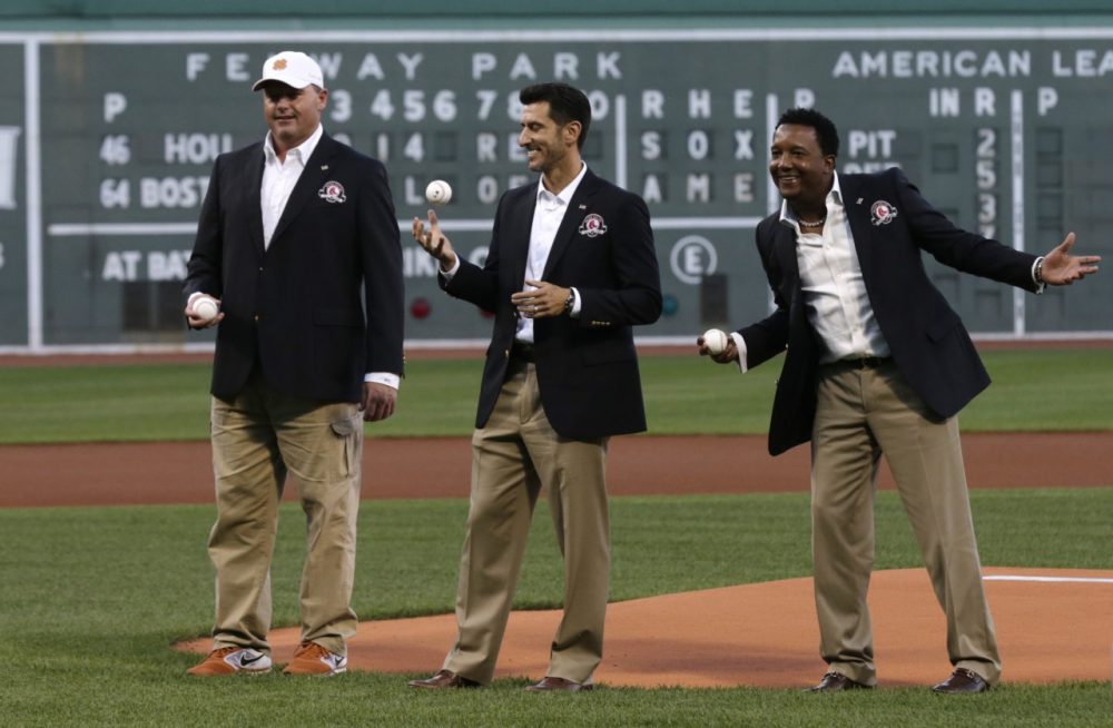 Boston Red Sox greats Roger Clemens, Nomar Garciaparra and Pedro Martinez before throwing out the ceremonial first pitch prior to a baseball game at Fenway Park in Boston, Thursday, Aug. 14, 2014. (AP)