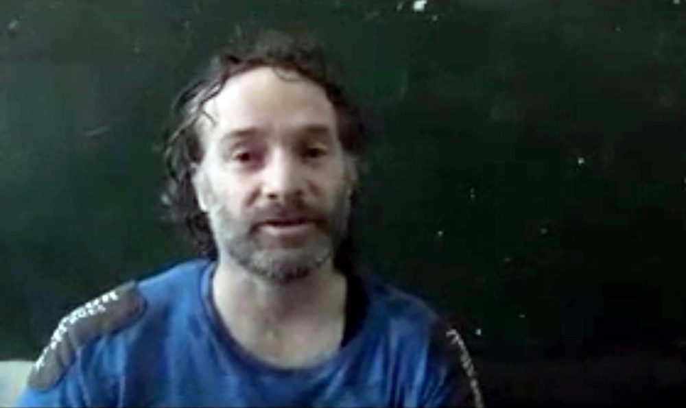 In this image made from undated video obtained by The Associated Press, a man believed to be Peter Theo Curtis, a U.S. citizen held hostage by an al-Qaida linked group in Syria, delivers a statement. (AP Photo)