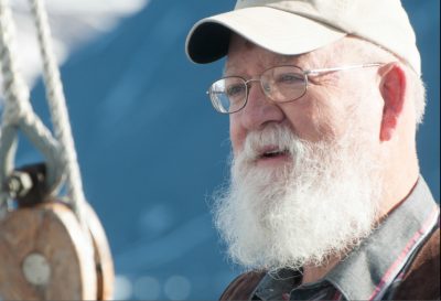 Tufts philosophy professor Daniel C. Dennett on a schooner in Greenland earlier this year. (Photo: Phil Wickens)