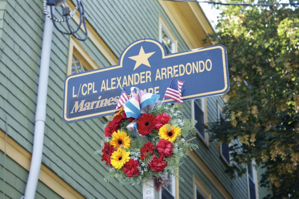 A ceremony today rededicated the corner of St. Rose street and South street in Jamaica Plain to Lance Corporal Alexander Scott Arredondo Square. It is across the street from the house in which Lance Corporal Arredondo grew up. (Qainat Khan/WBUR)