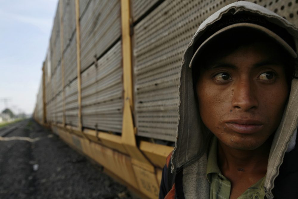 An unidentified migrant from Honduras waits for a northern bound train during his journey toward the US-Mexico border. (AP/Marco Ugarte)
