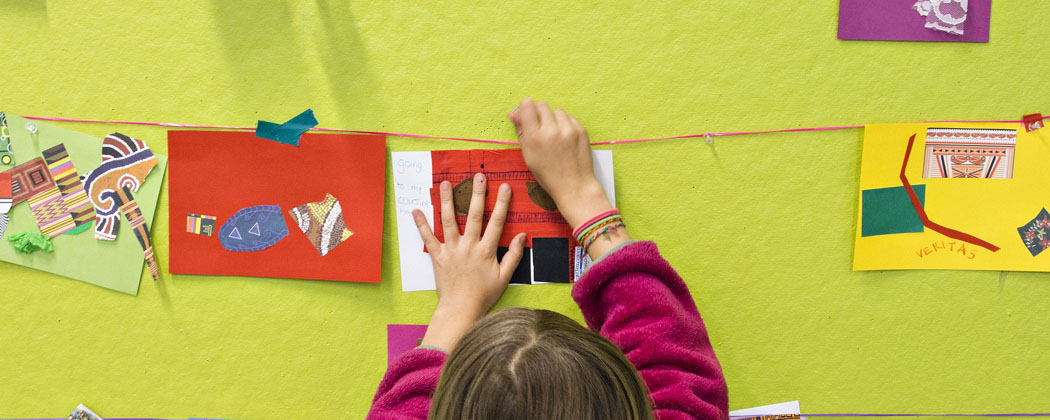 A child hangs art during one of the Museum of Fine Arts, Boston community days. (Courtesy MFA)