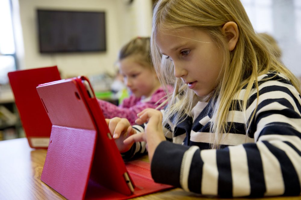 Ella Russell, 7, works on an e-book on an iPad during her second grade class at Jamestown Elementary School in Arlington, Va. (Jacquelyn Martin/AP)