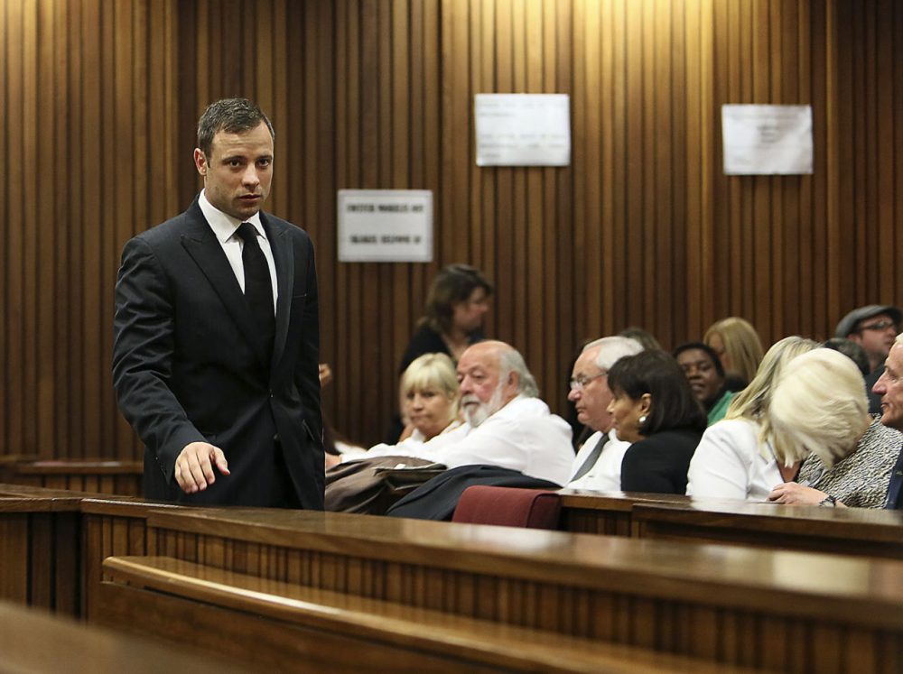 Oscar Pistorius, left, passes family members of the late Reeva Steenkamp on his arrival in court in Pretoria, South Africa, on Friday. (Alon Skuy/AP)