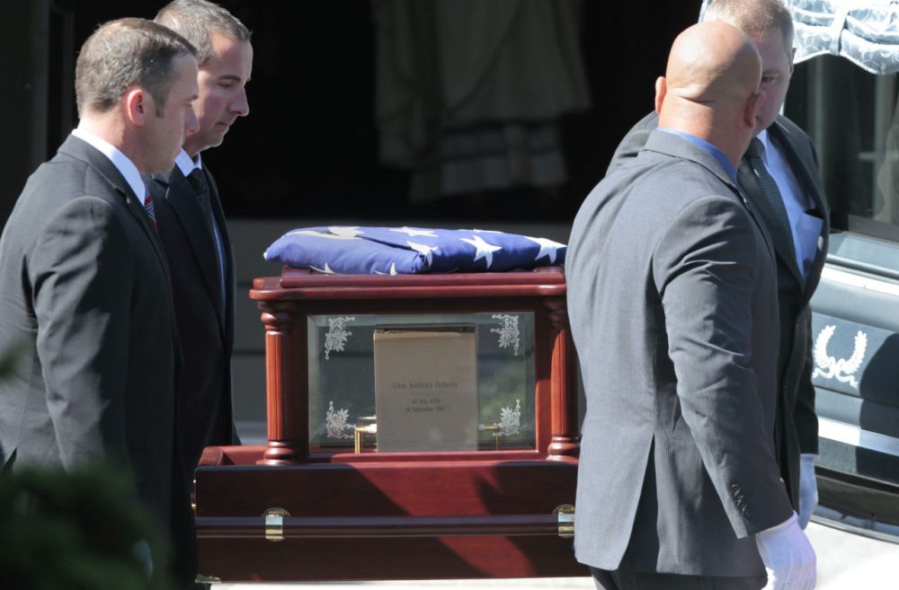The casket of former Navy SEAL Glen Doherty is carried into the Church of St. Eulalia in Winchester, Mass. in 2012. (Elise Amendola/AP)