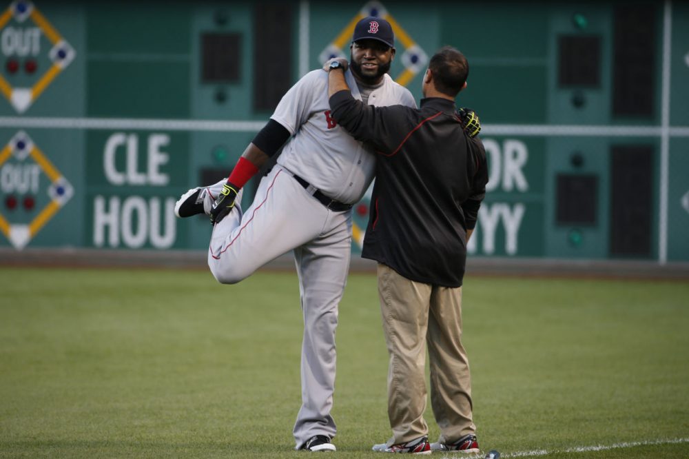 Boston Red Sox's David Ortiz, left, warms up with the help of a team trainer before a baseball game against the Pittsburgh Pirates in Pittsburgh Thursday. (Gene J. Puskar/AP)