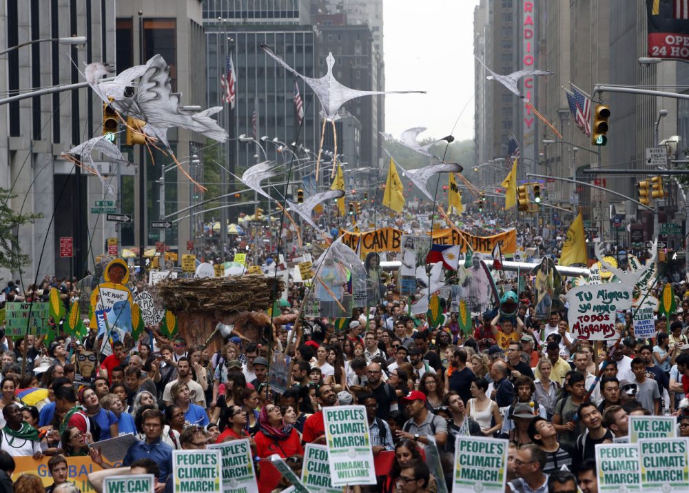 Demonstrators make their way down Sixth Avenue in New York during the People's Climate March Sunday, Sept. 21, 2014. (Jason DeCrow/AP)