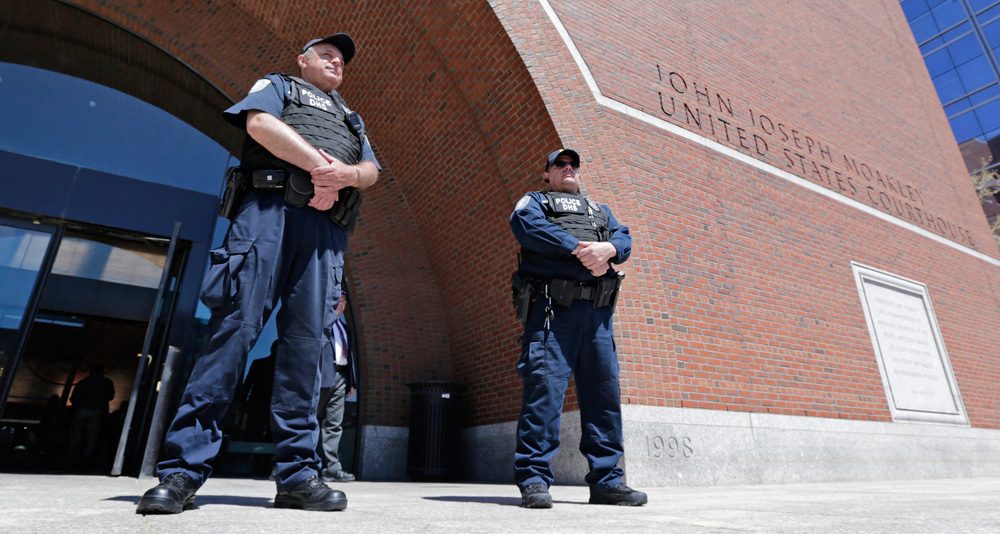 Department of Homeland Security police officers stand watch outside the Moakley Federal Courthouse in Boston on May 1, 2013. (Charles Krupa/AP)