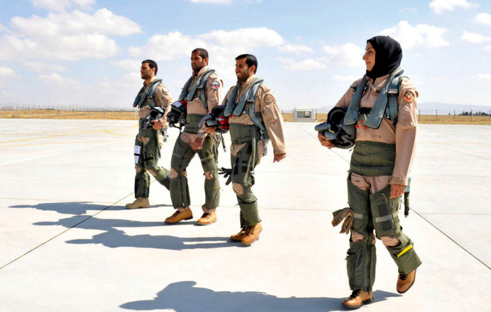 In this June 13, 2013 photo provided by the Emirates News Agency, WAM, Maj. Mariam al-Mansouri, the first Emirati female fighter jet pilot, right, walks with other pilots at an undisclosed location in United Arab Emirates. Maj. al-Mansouri was involved in strikes against ISIS militants.(Emirates News Agency, WAM via AP)
