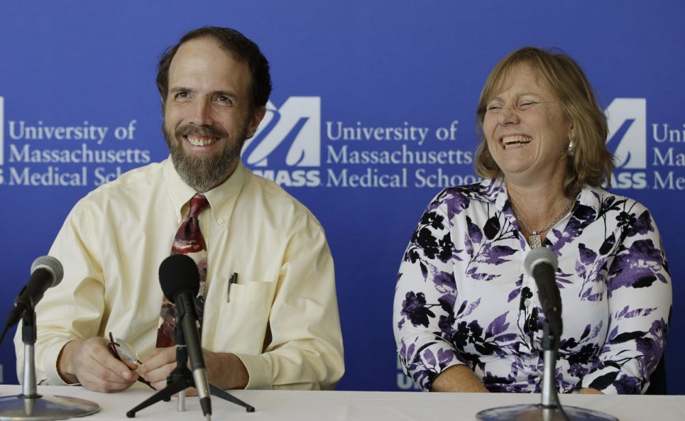 Dr. Rick Sacra, an American doctor who contracted the Ebola virus in Africa and his wife Debbie, enjoy a moment of levity during a news conference at the University of Massachusetts Medical School on Sept. 26. (Stephan Savoia/AP)