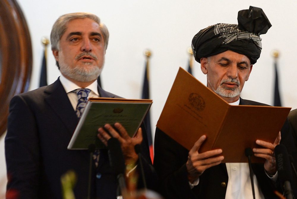 Newly-sworn in Afghan President Ashraf Ghani (R) administers the oath to Abdullah Abdullah (L) as Afghanistan's new Chief Executive during the swearing in ceremony for the country's new president on September 29, 2014. (Shah Marai/AFP/Getty Images)