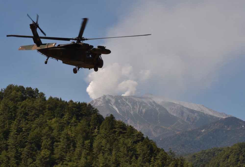 A military helicopter leaves a temporary landing site for a resque mission on Mount Ontake in Otaki, Nagano prefecture on September 29, 2014.  (Kazuhiro Nogi/AFP/Getty Images)